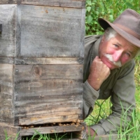 Bryan Divers, co-founder of Mamaki Farm and Village, poses with one of his Warre beehives.